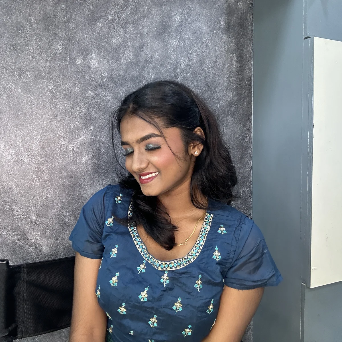 Bridal makeup for Muhurtham ceremony featuring traditional South Indian look with gold jewelry and flower garland